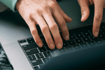person typing on laptop